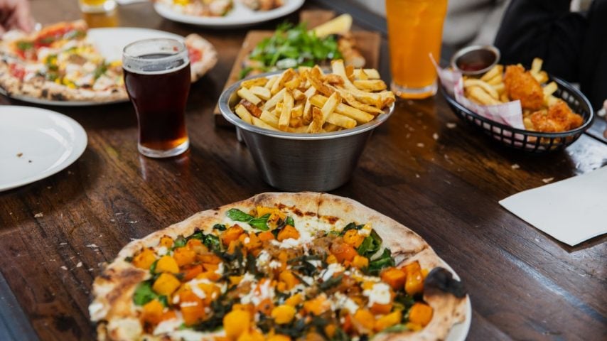 A table of beers, pizzas and chips at Little Creatures Brewery.