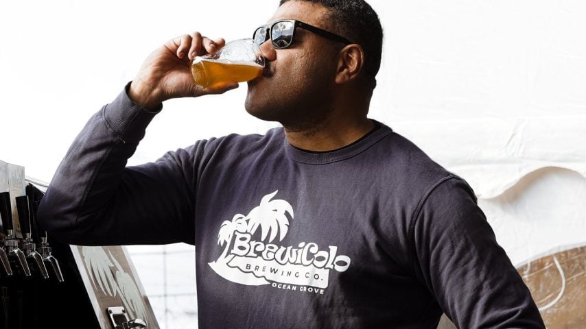 The BrewiColo owner wears sunnies and is drinking a pint of beer.