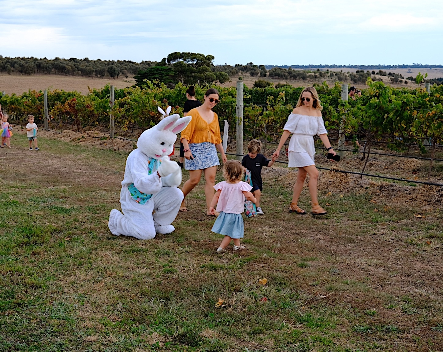 A family stand next to the vineyards and Easter Bunny at Austin's Wines
