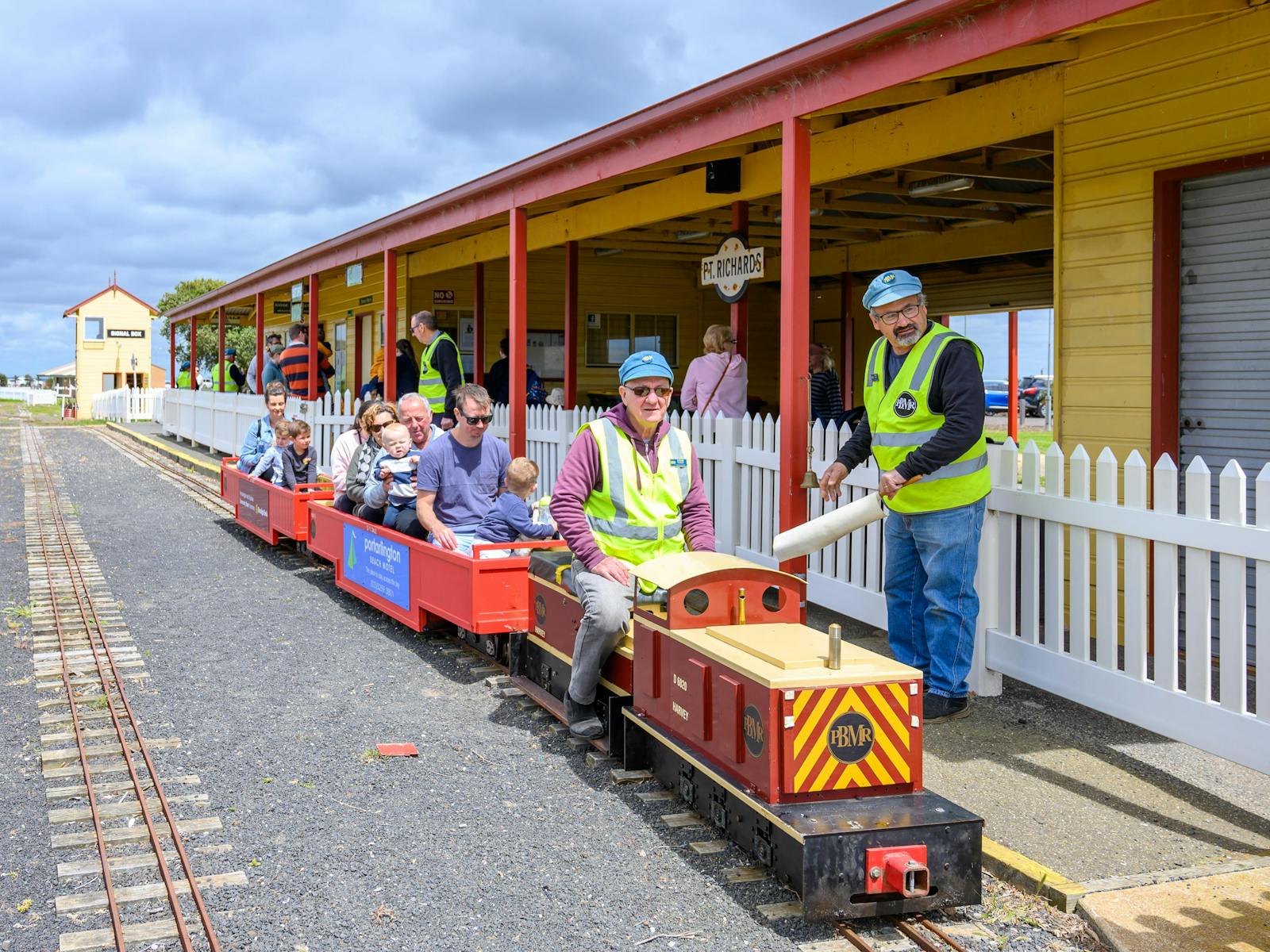A family sit on a mini train at Portarlington Miniature Railway.