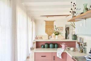 Pink kitchen with green canisters and aesthetic decor
