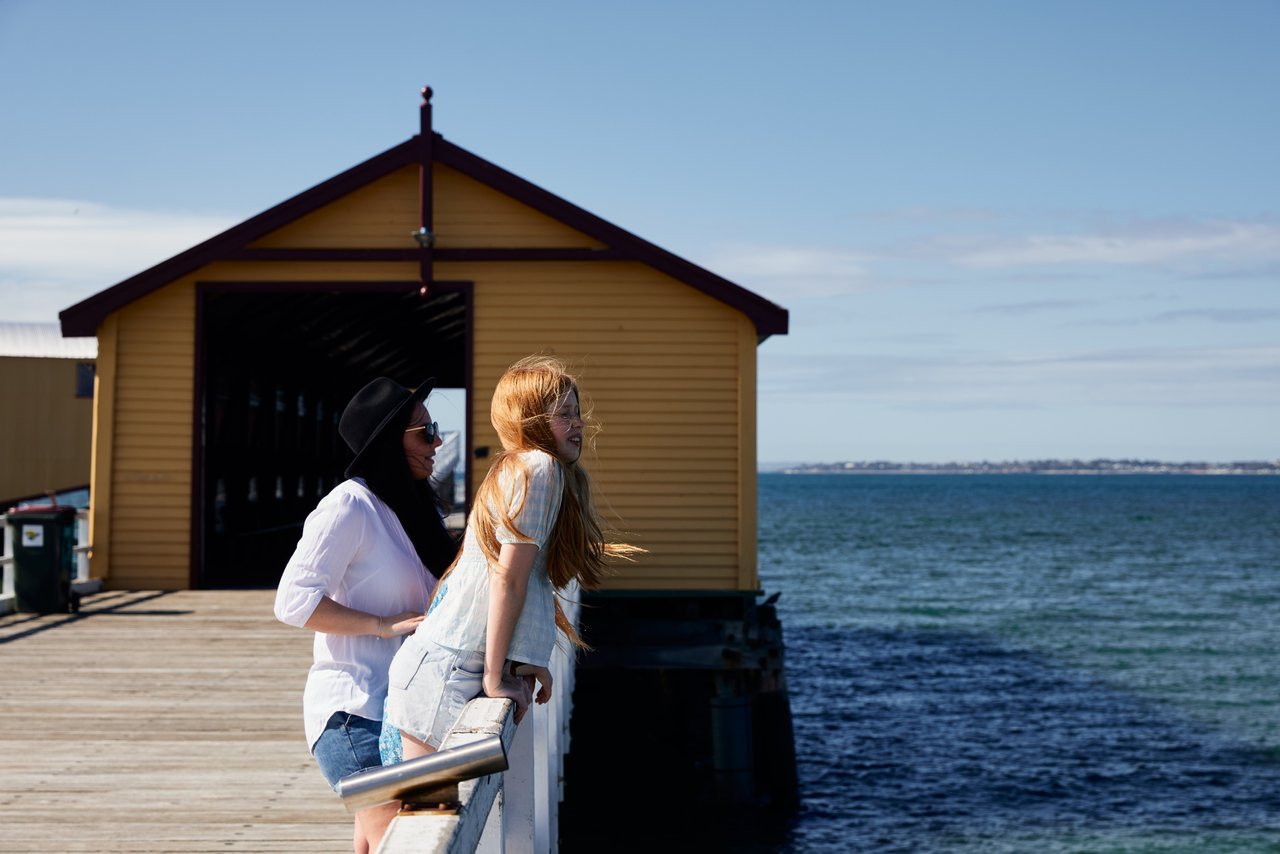 Mum and daughter on Queenscliff Pier looking out over ocean