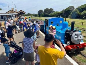 Thomas the Tank Engine train with spectators and families having photos