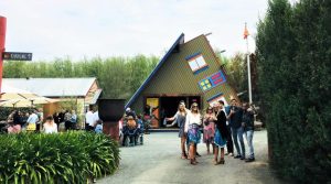 Upside down house with people standing in front