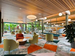 Inside of hotel lobby with green and orange chairs