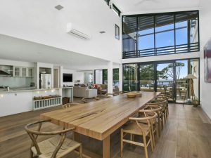 Long table with floor to ceiling windows and doors in rental house